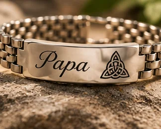 A steel bracelet, engraved with a name and a Celtic knot